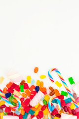 Assorted colorful bright candies on white background. Flat lay, top view