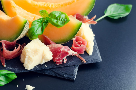Concept of italian food with melon and prosciutto