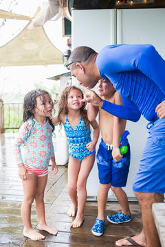 Man playfully scolding children