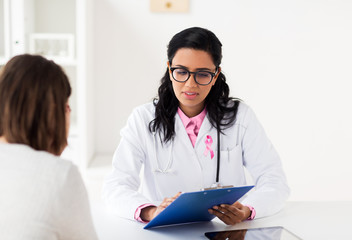 doctor with pink awareness ribbon and patient