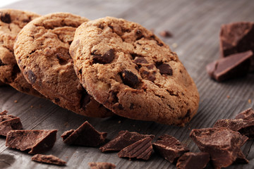 Chocolate cookies on wooden table. Chocolate chip cookies shot.
