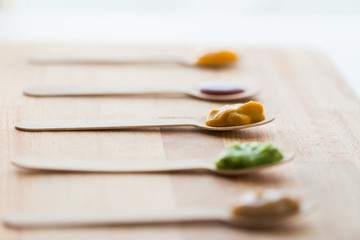 vegetable or fruit puree or baby food in spoons