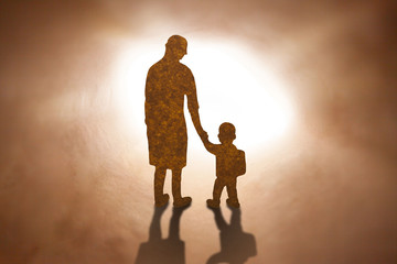 Mother and son walking Brown paper cut silhouette concept.
