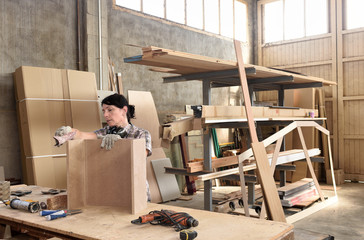 a woman working in a carpentry workshop