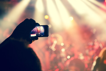Fans filming a gig with smart phones