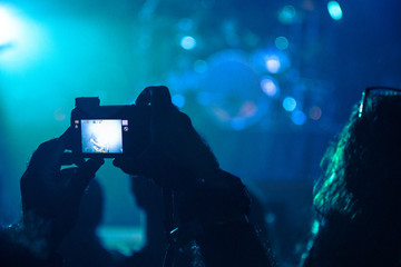 Fans filming a gig with smart phones