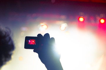 Fans filming a gig with smart phones