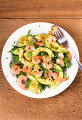 Shrimp salad with avocado arugula, scallion and almonds. View from above, top studio shot, vertical