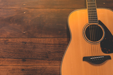 Wooden guitar. Close-up of guitar lying on vintage wood background
