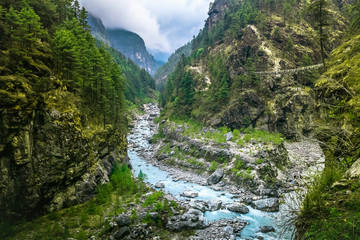 Fototapeta na wymiar Mountain Canyon Valley. Beautiful river landscape and mountain forest in Nepal. Trekking route to Everest Base Camp, Himalayas. Holidays, recreation. Travel background. Beautiful nature landscape
