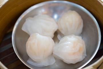 Top view fresh dumplings with hot steams on wood plate .Chinese food