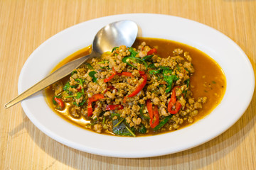 stir-fried with minced pork and basil on white plate (Ka Prao Moo)