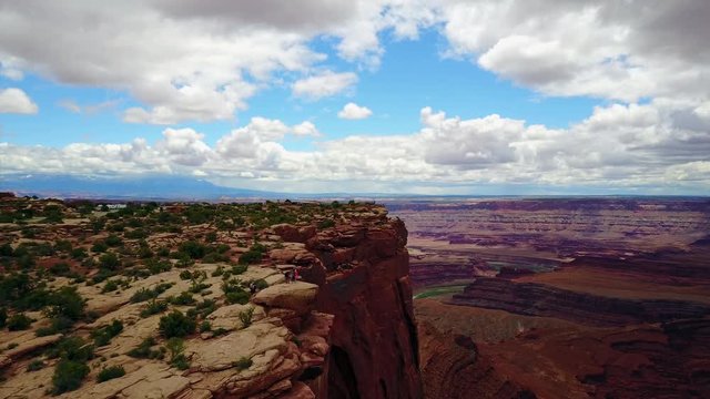 Aerial view of tourists taking pictures in Canyon Cliff 4K