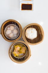 Top view fresh dumplings with hot steams on wood plate .Chinese food