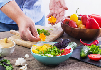 man cooking a vegetarian salad