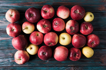 Rustic natural apples over old wooden background