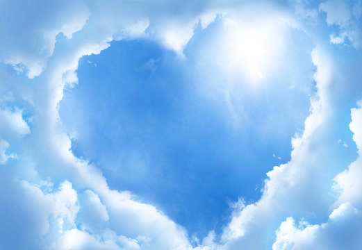 Heart frame shaped clouds on sky background.