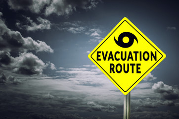 Hurricane evacuation road sign with dramatic sky background