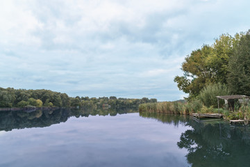 Fishing sigean serving water calm lake. Evening landscape