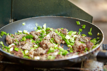 Ham with chives frying on pan