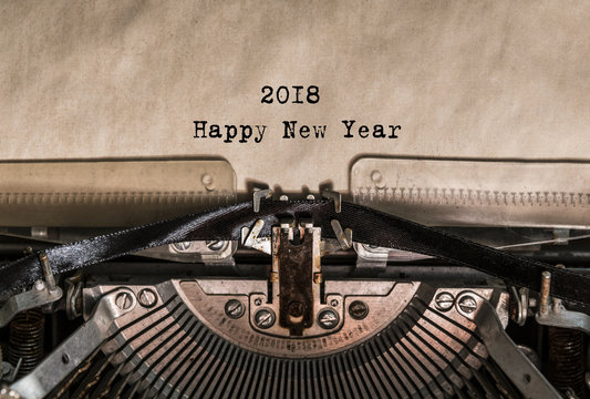 Happy New Year 2018 words typed on a Vintage Typewriter. Mechanisms closeup. Typing on old typewriter. Greeting card with a holiday