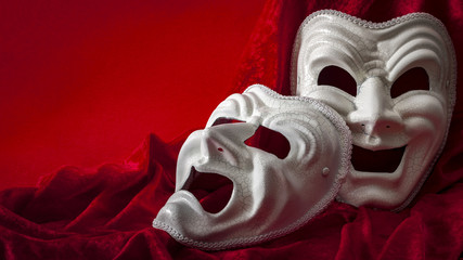 Theatre and opera concept with theatrical masks on red velvet. In Greek mythology Thalia was the...