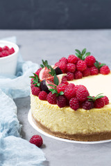 Cheesecake with raspberries and figs on a gray background, raspberry, berries, cake, vertical, selective focus, sweets