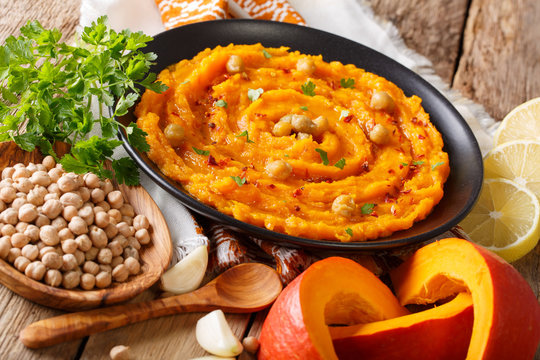 Healthy vegetarian food: pumpkin hummus with ingredients close-up. horizontal