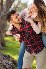 Fototapeta premium Portrait of a happy young couple in the nature hugged together