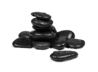Black spa stones with water drops isolated on white background