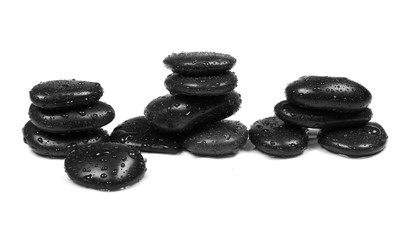 Black spa stones with water drops isolated on white background