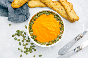 Pumpkin soup in white bowl