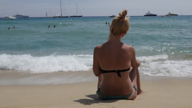 Sunbathing of woman on beautiful beach slow motion - Caucasian female on French coast slow-mo video 