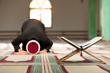 Young Imam praying inside of beautiful mosque © FS-Stock