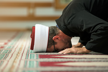 Young Imam praying inside of beautiful mosque © FS-Stock