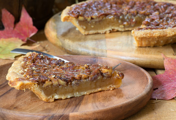 Slice of Pecan Pie on a Wooden Plate