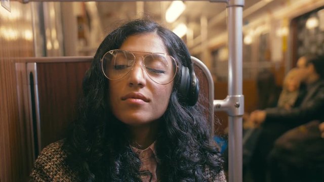 Woman listening to music on the subway
