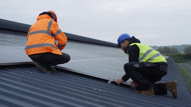  Technicians checking the panels at solar energy installation