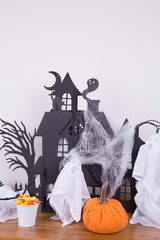 Halloween decoration with a haunted house and a pumpkin 