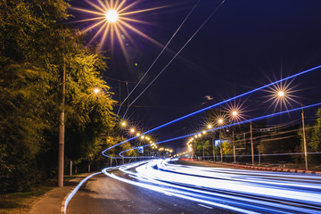 Fototapeta na wymiar Traffic light trails on night urban road