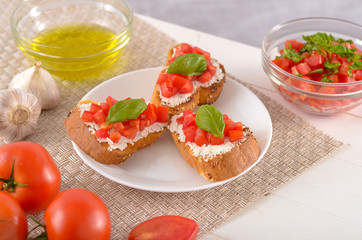 delicious bruschetta with tomatoes on plate on table close-up