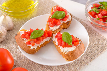 delicious bruschetta with tomatoes on plate on table close-up