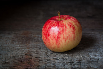 Red and yellow apple on old wooden background