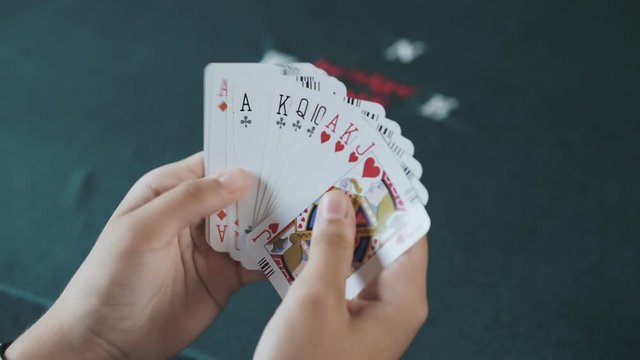 Bridge card game,female hand  shuffling cards close up