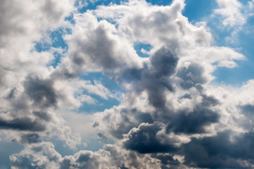 Fototapeta na wymiar Gray cumulus fluffy clouds