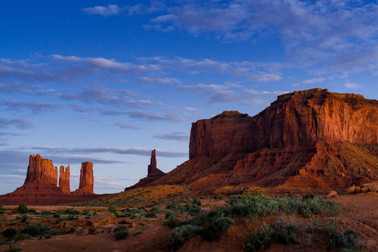 Monument Valley Utah USA Landscape in Late Evening Lit by Moon Light under Stars &amp; Cloudy Sky