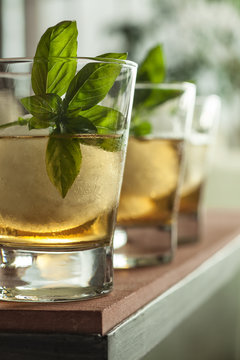 Whiskey cocktail with large ice cube