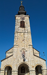 Fototapeta na wymiar Clock tower on church in Sremska Kamenica, Serbia