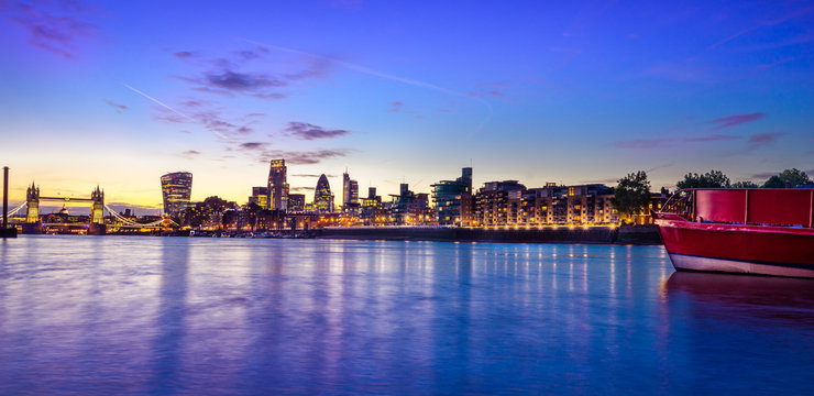 London Skyline At Dusk Including Tower Bridge And Skyscrapers At Financial District