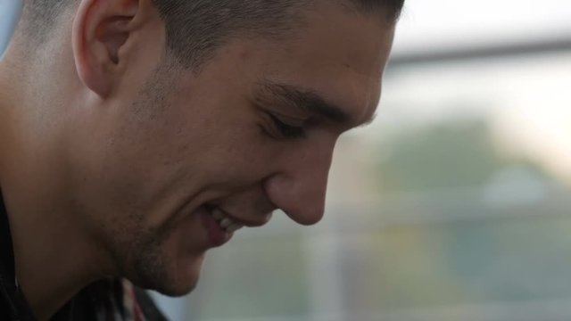 close-up of a man breathing vapor and smoking an electronic cigarette